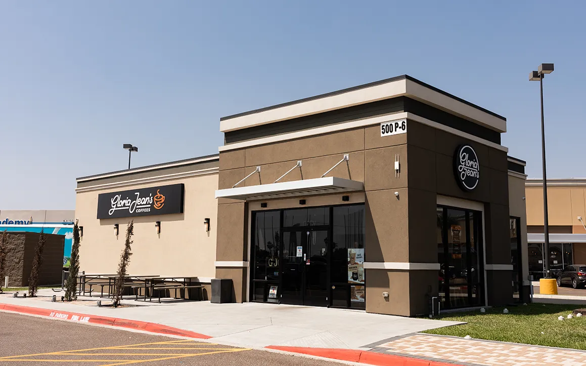A Gloria Jean's Coffees store exterior with the signature above the door